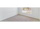Bright bedroom featuring neutral carpeting, base molding, and natural light from window at 449 S Salida St, Aurora, CO 80017