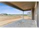 A covered patio offers a view of a large lot in a new construction community and features concrete flooring at 449 S Salida St, Aurora, CO 80017