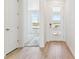 Bright entryway featuring a modern door with glass panels and light wood flooring at 449 S Salida St, Aurora, CO 80017