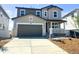 Charming two-story home featuring a two-car garage, covered porch and manicured front yard at 449 S Salida St, Aurora, CO 80017