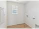 Bright laundry room with light wood floors, window, and utility hookups, ready for appliances at 449 S Salida St, Aurora, CO 80017