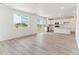 Spacious living area open to the kitchen, featuring large windows and light hardwood floors at 449 S Salida St, Aurora, CO 80017