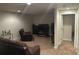 Basement area with plush carpeting, a comfy armchair, and a modern entertainment center with TV at 15501 E 112Th Ave # 28E, Commerce City, CO 80022