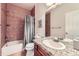 Warm-toned bathroom with a granite countertop, bathtub-shower combo, and ample lighting at 15501 E 112Th Ave # 28E, Commerce City, CO 80022