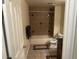 Cozy bathroom featuring neutral ceramic tile, a shower-tub combination, and a dark vanity at 15501 E 112Th Ave # 28E, Commerce City, CO 80022