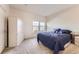 Bedroom with neutral carpet, minimalist decor, and windows providing natural light at 15501 E 112Th Ave # 28E, Commerce City, CO 80022