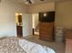 Bedroom features an ensuite bath, stairs, and natural wood furniture at 15501 E 112Th Ave # 28E, Commerce City, CO 80022