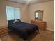 Inviting bedroom with a large window, a comfortable bed, and coordinated furniture at 15501 E 112Th Ave # 28E, Commerce City, CO 80022
