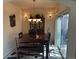 The dining room features a wooden table, chandelier, and sliding glass door at 15501 E 112Th Ave # 28E, Commerce City, CO 80022