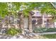 Inviting townhouse entrance with stone accents and a charming covered patio area at 15501 E 112Th Ave # 28E, Commerce City, CO 80022
