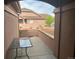 Outdoor patio space with a small glass table, showing building facade and small trees at 15501 E 112Th Ave # 28E, Commerce City, CO 80022
