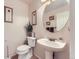Charming powder room with pedestal sink, framed artwork, and neutral finishes at 15501 E 112Th Ave # 28E, Commerce City, CO 80022