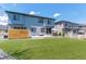 Expansive backyard showcasing a well-maintained lawn, patio furniture and modern fence at 7240 S White Crow Way, Aurora, CO 80016