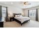 Bright bedroom with neutral tones, furniture, and a ceiling fan at 7240 S White Crow Way, Aurora, CO 80016