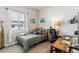 A comfy bedroom featuring a twin bed, a desk, and a window at 7240 S White Crow Way, Aurora, CO 80016