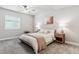 Bright bedroom with neutral tones, a ceiling fan and large windows at 7240 S White Crow Way, Aurora, CO 80016