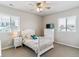 Bright bedroom featuring a white bed frame, neutral walls and carpet, and lots of natural light at 7240 S White Crow Way, Aurora, CO 80016