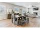Open dining area with wood table, bench, and views of the living room, great for Gathering meals and gatherings at 7240 S White Crow Way, Aurora, CO 80016