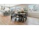 Charming dining area with a rustic wooden table, bench seating, and views of the surrounding neighborhood at 7240 S White Crow Way, Aurora, CO 80016