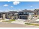 Beautiful two-story home with stone accents, manicured lawn, and a two-car garage at 7240 S White Crow Way, Aurora, CO 80016