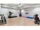Spacious home gym with a variety of exercise equipment and natural light at 7240 S White Crow Way, Aurora, CO 80016