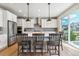 Modern kitchen featuring stainless steel appliances, a center island with barstool seating, and ample cabinet space at 7240 S White Crow Way, Aurora, CO 80016
