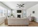 Inviting living room featuring a fireplace, comfortable sofas, and large windows for plenty of natural light at 7240 S White Crow Way, Aurora, CO 80016
