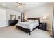 Relaxing main bedroom with neutral tones, dresser, and a ceiling fan at 7240 S White Crow Way, Aurora, CO 80016
