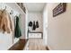 Functional mudroom with hooks, built-in bench, and storage cabinets at 7240 S White Crow Way, Aurora, CO 80016