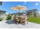 Outdoor dining space featuring a large patio umbrella and a dining table at 7240 S White Crow Way, Aurora, CO 80016