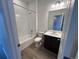 Clean bathroom featuring a shower-tub combo, vanity and modern fixtures at 6599 N Netherland St, Aurora, CO 80019