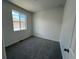 Bedroom features carpet, neutral walls, and a bright window at 6599 N Netherland St, Aurora, CO 80019
