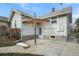 Backyard featuring a small covered patio and partial privacy fence at 3226 S Grant St, Englewood, CO 80113