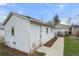 View of garage with white painted siding, and a cement walkway at 3226 S Grant St, Englewood, CO 80113