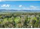 Stunning aerial view of golf course community with beautiful mountain views and lush green landscape at 4667 Ashfield Dr, Boulder, CO 80301