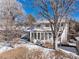 Back exterior featuring an enclosed sunroom with many windows and a well-maintained yard with mature trees at 4667 Ashfield Dr, Boulder, CO 80301