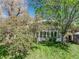 Backyard view with mature trees surrounding a sunroom addition and a storage shed, providing serene privacy at 4667 Ashfield Dr, Boulder, CO 80301