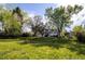 Spacious backyard with lush greenery, mature trees, and ample space for recreation at 4667 Ashfield Dr, Boulder, CO 80301