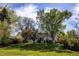 Expansive backyard featuring a well-maintained lawn, mature trees, and scenic views at 4667 Ashfield Dr, Boulder, CO 80301