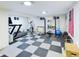 Basement featuring workout equipment and checkered flooring, providing a great space for fitness activities at 4667 Ashfield Dr, Boulder, CO 80301