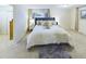 Bright bedroom featuring a stylish bed with a tufted headboard and elegant decor at 4667 Ashfield Dr, Boulder, CO 80301