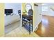 Inviting entryway featuring a shoe rack with decor, tiled floors, and hardwood floors beyond at 4667 Ashfield Dr, Boulder, CO 80301