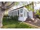 Exterior view of home featuring bright sunroom, deck with seating, and lush green lawn at 4667 Ashfield Dr, Boulder, CO 80301