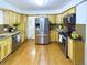 Bright kitchen featuring stainless steel appliances, wooden cabinets, and a view to the laundry room at 4667 Ashfield Dr, Boulder, CO 80301