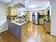 Well-lit kitchen featuring wood cabinetry, stainless steel appliances, and a gas cooktop on the island at 4667 Ashfield Dr, Boulder, CO 80301