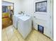 Functional laundry room with a washer, dryer, and a door with a pet door and exterior view at 4667 Ashfield Dr, Boulder, CO 80301