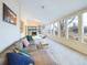 Bright sunroom with large windows, carpet floors, comfortable seating and access to backyard area at 4667 Ashfield Dr, Boulder, CO 80301