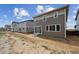 New construction home featuring a gray and brown exterior with a sliding glass door to the backyard at 45915 Wood Thrush Ave, Bennett, CO 80102