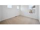 Well lit bedroom with carpet flooring and multiple windows at 45915 Wood Thrush Ave, Bennett, CO 80102