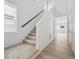 Bright entryway featuring wood floors, neutral walls, carpeted stairs, and a window for natural light at 45915 Wood Thrush Ave, Bennett, CO 80102
